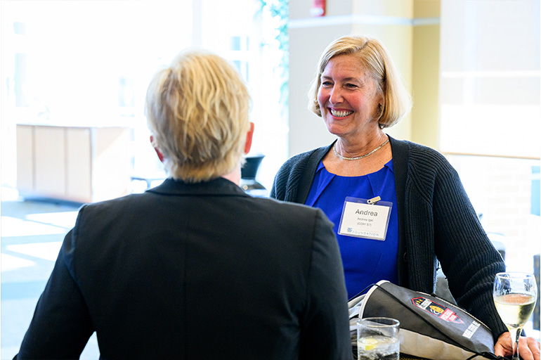Dr. Andrea Igel smiles while chatting with a guest