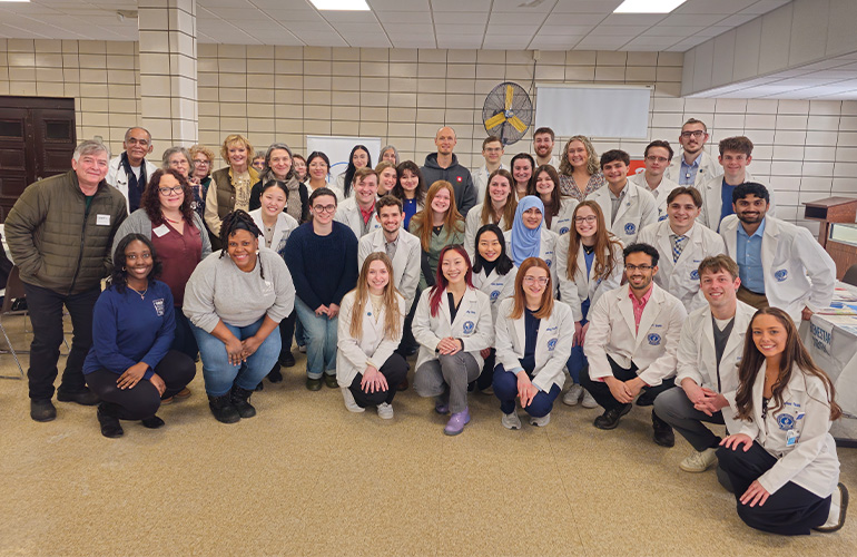 Large group volunteers pose together
