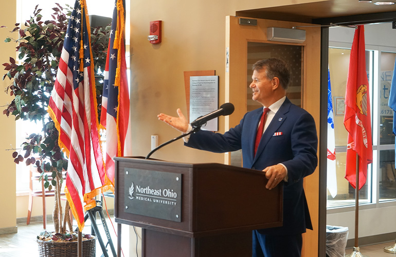 NEOMED President John Langell at podium