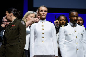 Two members of the U.S. Navy during a pinning ceremony at commencement
