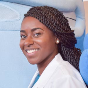 A pharmacy student in a white coat.