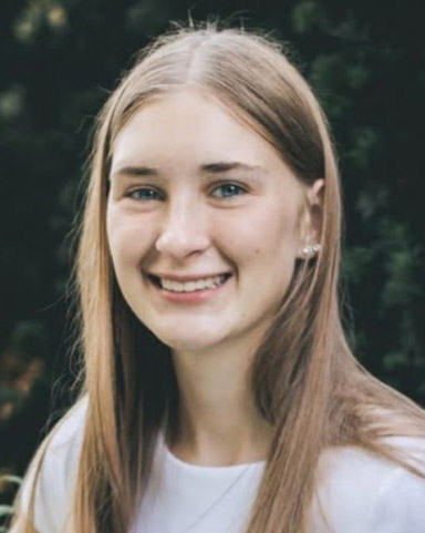 Portrait of Halley Fritz, standing outside.