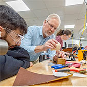 A faculty member shows a student how equipment works in medical-device lab at NEOMED.