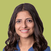 A student looks at the camera, smiling.