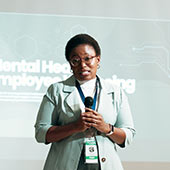 A faculty member gestures while delivering a classroom lecture.