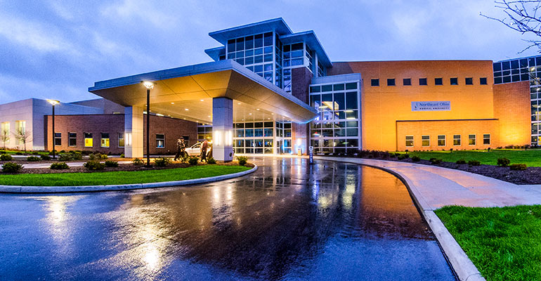 The exterior of NEOMED on a rainy evening.
