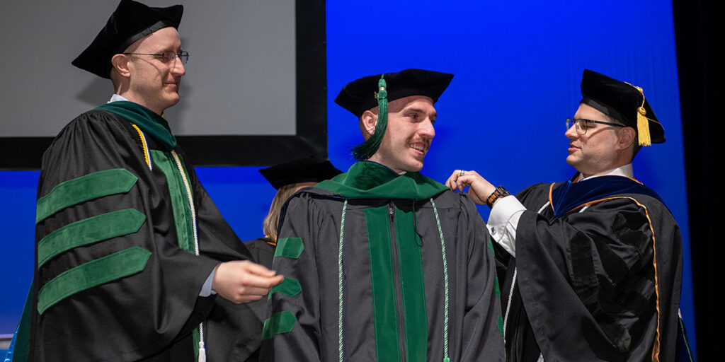 Students select hooders for 2025 Commencement