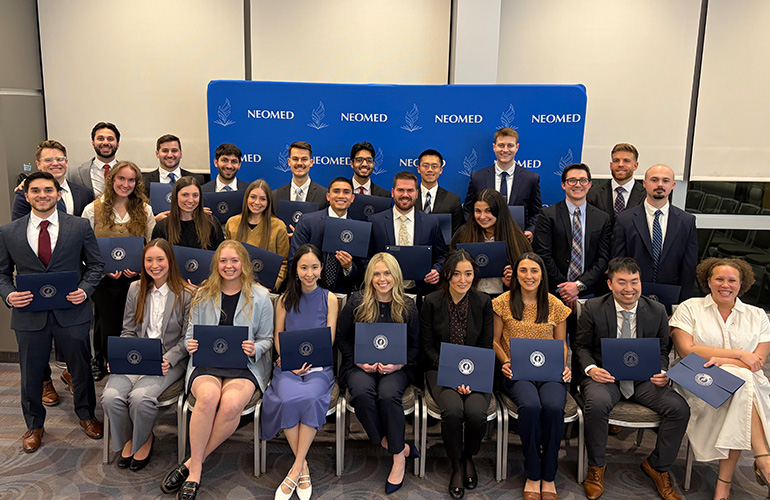 Junior AOA inductees pose together with their certificates