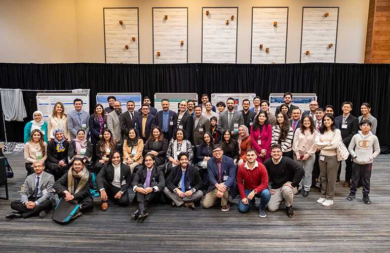 large group of smiling people at a conference
