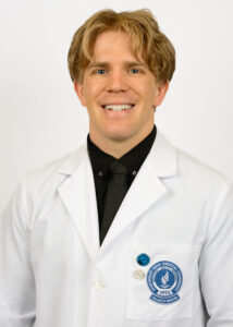 Headshot of Grant Neukom in white coat