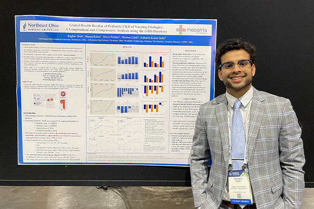 Raghav Shah poses with his poster as nephrology conference
