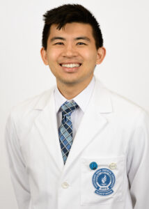 Headshot of Justin Lu wearing a white coat