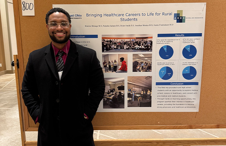 Klarens Menage with his poster