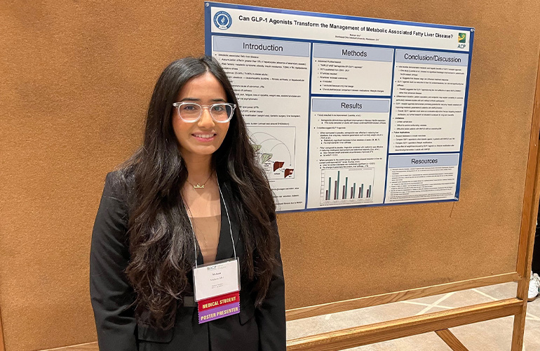 Maham Alvi with her poster
