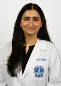 Headshot of Mehak Behal wearing a white coat