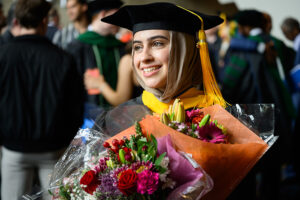 A College of Medicine graduate smiles at commencement.