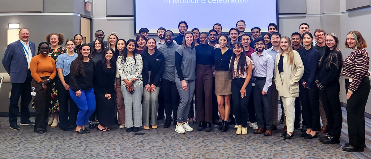 About 30 first-generation students post for a photo.