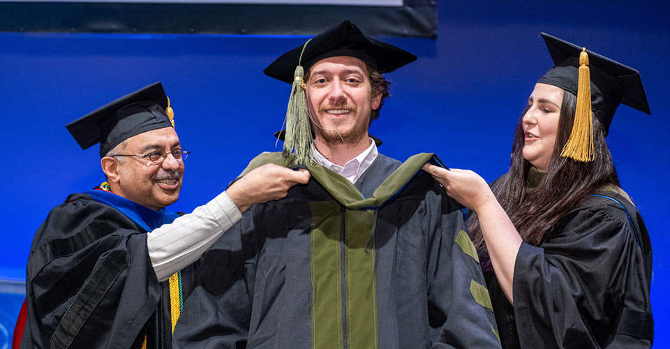 Graduating students select Commencement hooders