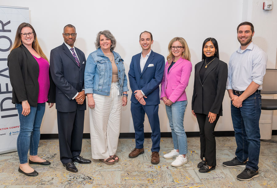 A team of six who participated in a joint NEOMED-UH event stand against a wall for a photo.