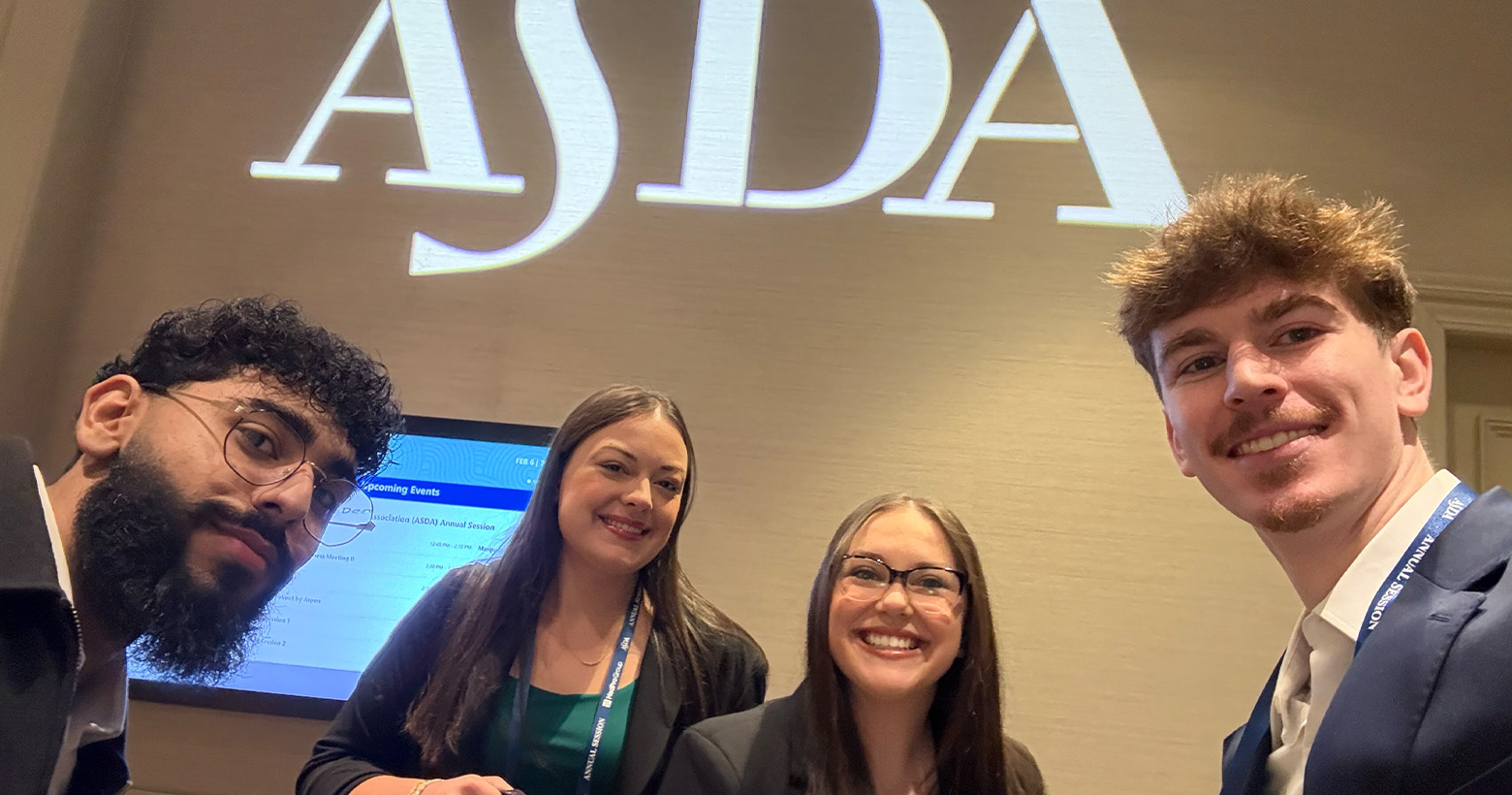 Four dental students pose with the ASDA sign
