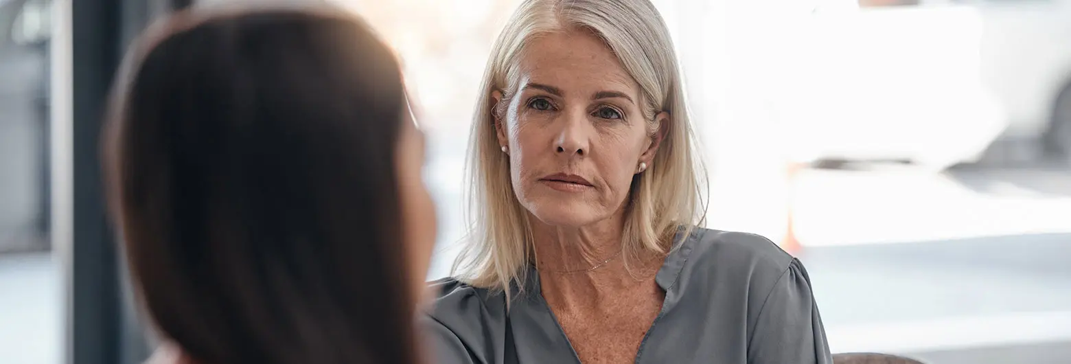A certified mental health assistant talks with a client during a counseling session.