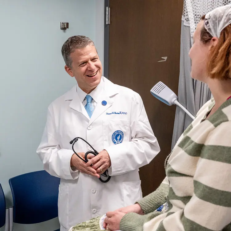 A physician at DeWeese Health Center greets a Kent State student at the beginning of an appointment.