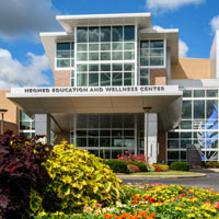 Flowers in bloom in front of the NEW Center at NEOMED.