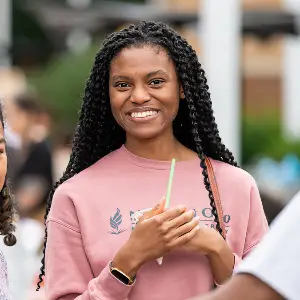 A NEOMED student smiles at a campus event.