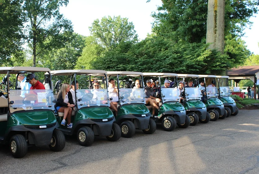 A row of golf carts is loaded and ready for the shotgun start.