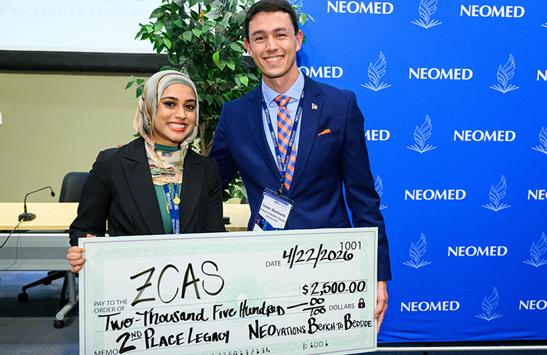 Two people holding an oversized check.