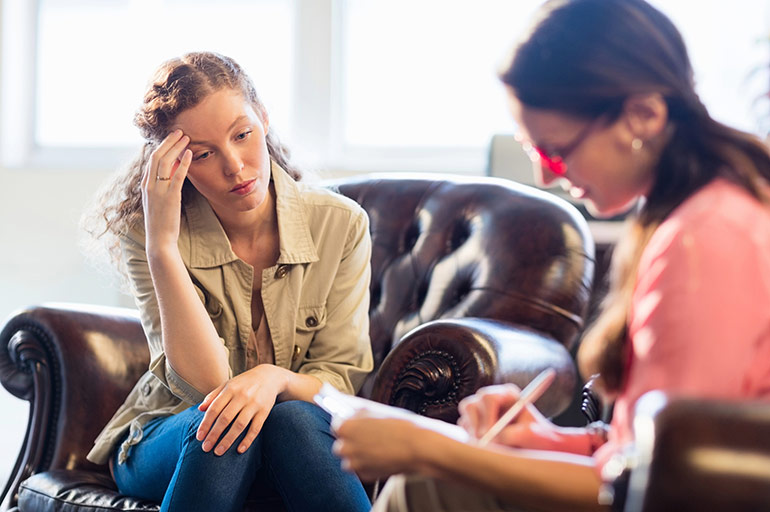 A woman talks with her mental health professional during an appointment.