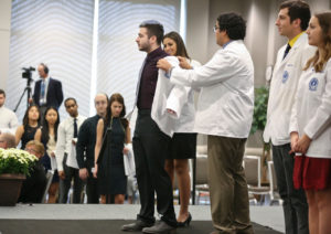 Student receiving white coat