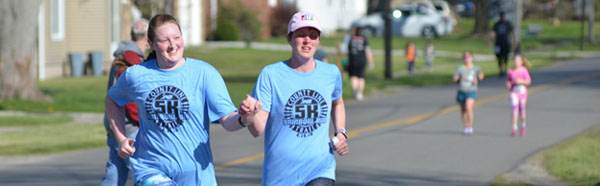 Individuals running at the Rainbow Color Fun Run