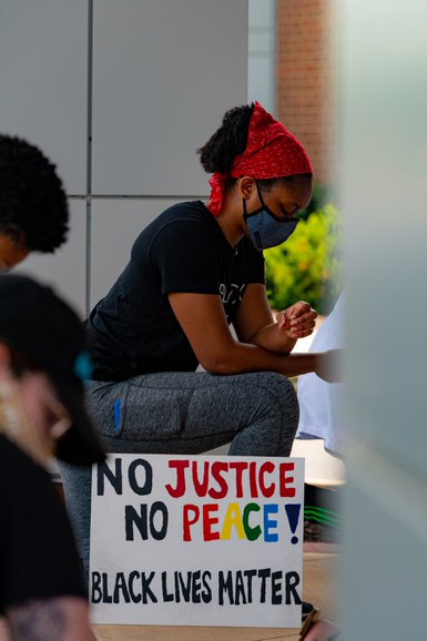A student kneeling for eight minutes and forty-six seconds in solidarity