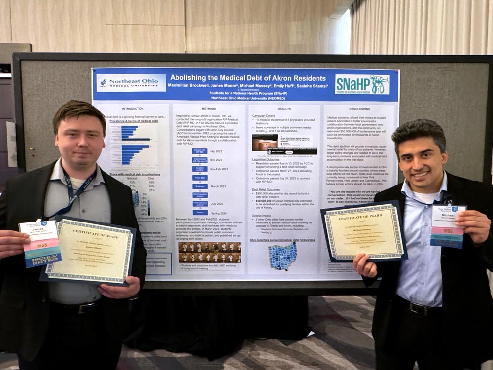 Medicine students James Moore and Michael Massey earned a People’s Choice Award for their poster on the debt-relief.