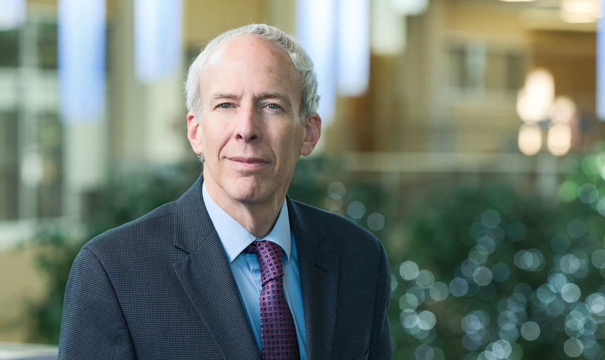 Dean Marc Basson of NEOMED's College of Medicine stands in the artium at the university.