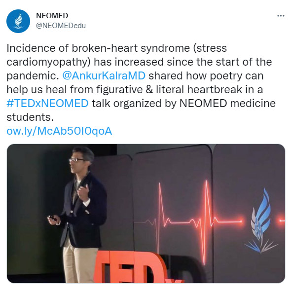 A twitter post showing a man speaking before a group.