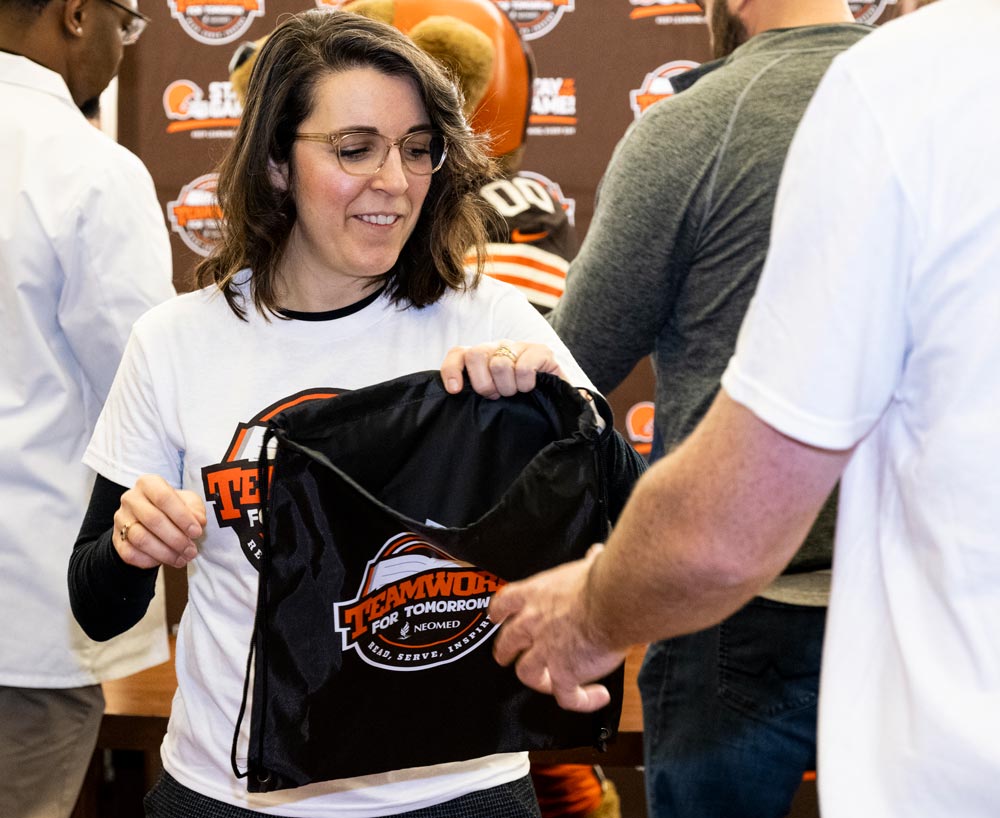 A NEOMED faculty member prepares reading kits for the students.