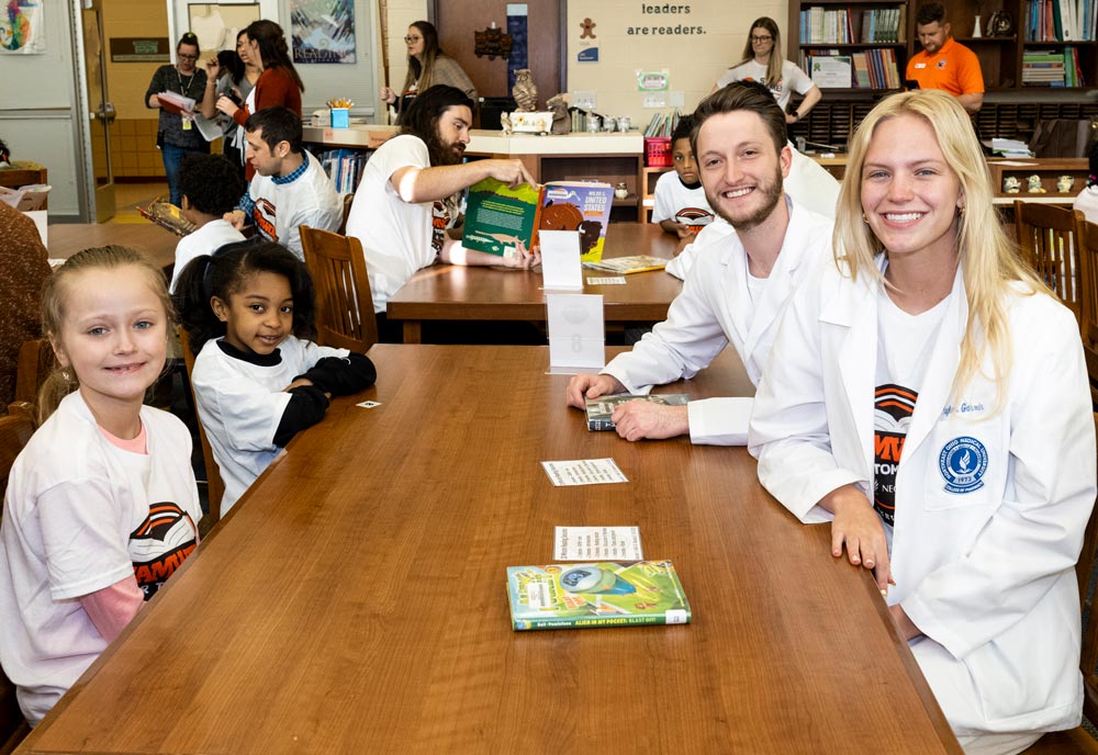 Pharmacy students from NEOMED read with Akron Public Schools students.