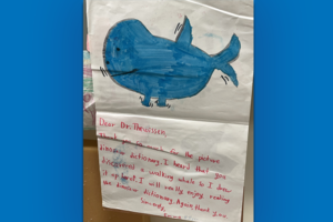 child's drawing of a walking whale above a handwritten thank you note