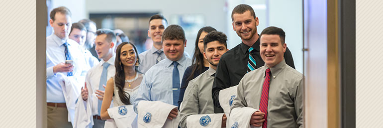 A group of future Certified Anesthesiologist Assistants with their white coats.