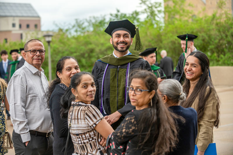A graduate with his family following the ceremony.