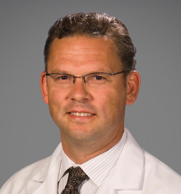 A village in Nepal, surrounded by green mountains.