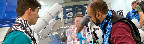 Three medical students reading poetry.
