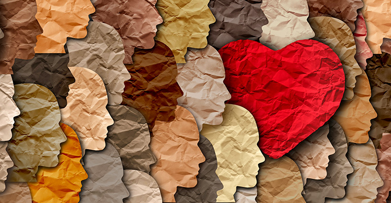 A collage of human faces, with a heart embedded within.