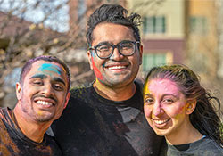Students with color dye on their face during an outdoor spring festival.
