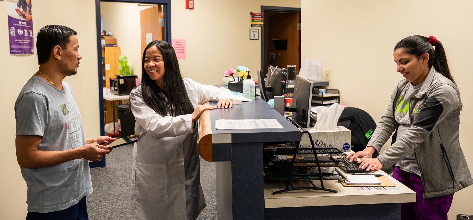 In an doctor's office, a physician talks with a patient.