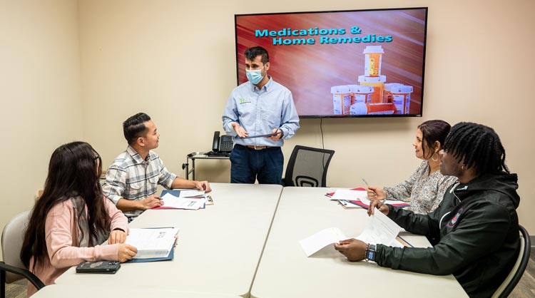 In an doctor's office, a physician talks with a patient.