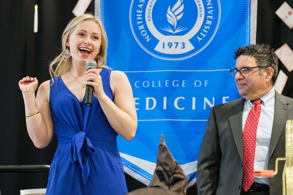 Surrounded by family, a medical student opens the envelope that indicates where she will spend her residency.