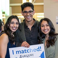 A medical student with family members holds a sign that says, "I Matched."